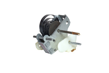 wind-up mechanism of vintage toy. power spring and gear in metal housing, attached plastic element, metal rods, bar for spring tightening. isolated on white background