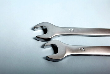 Wrench and spanner on a blue background, close-up