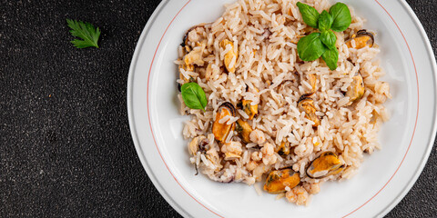Seafood rice risotto frut de mer mussels, shrimp, prawn, rapan, squid vegetable dish fresh delicious gourmet food background on the table rustic food top view copy space