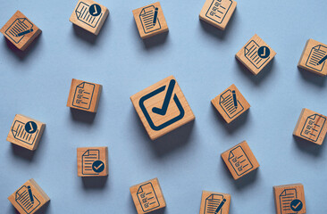 Fototapeta na wymiar Correct tick sign mark on wooden block cube among document preparation check and approve for ISO and quality audit concept.