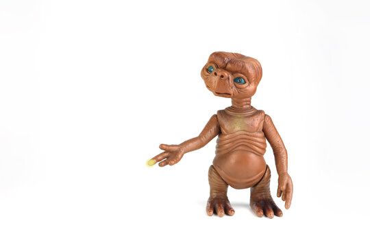 model action figure toy of character from E.T. extra terrestrial American science fiction film display on black shelf with rocks black background in toy store during Universal cinema Hollywood movies