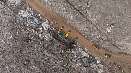 Trucks are collecting waste in large piles for disposal and recycling.