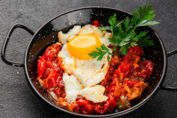 Fried egg tomatoes shakshuka vegetable dish appetizer fresh delicious gourmet food background on the table rustic food top view copy space vegetarian  food