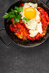 Fried egg tomatoes shakshuka vegetable dish appetizer fresh delicious gourmet food background on the table rustic food top view copy space vegetarian  food