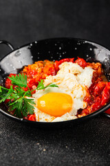 Fried egg tomatoes shakshuka vegetable dish appetizer fresh delicious gourmet food background on the table rustic food top view copy space vegetarian  food