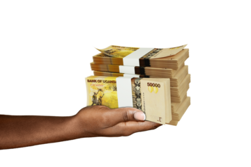 Hand Holding 3D rendering of stacks of Ugandan shilling notes isolated on transparent background