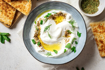 Labneh yogurt cream cheese with olive oil, herbs and zaatar