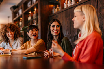 Cheerful businesswomen having fun chatting together in cafe