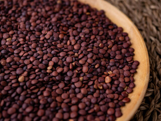 Fototapeta premium Organic uncooked seeds dark red brown lentils.