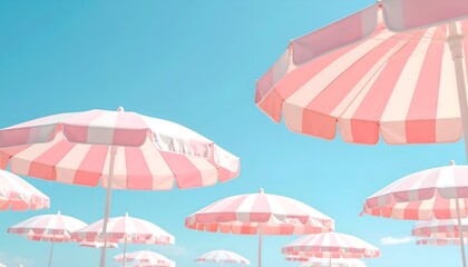 soft Pink and white striped beach umbrellas under a clear blue sky, space for copy