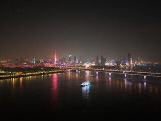 Fototapeta premium aerial Wuhan city night, Wuhan Yangtze River Bridge and tour boat, high angle view