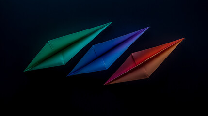 Three colorful paper aeroplanes displayed against a dark background representing creativity and movement