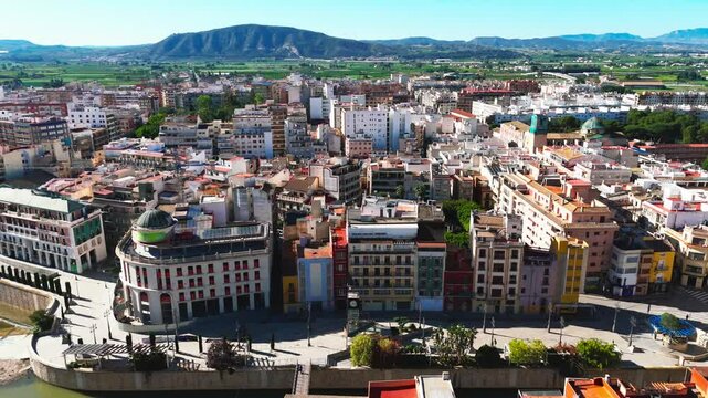 Drone point of view ancient spanish city of Orihuela, aerial shot of architecture and Segura River canal during sunny summer day. Costa Blanca, Alicante province. Spain