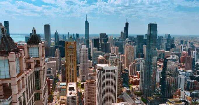 Flight over skyscrapers in modern Chicago, Illinois, USA. Drone flight over city downtown at daytime.