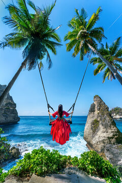 Tourist on Bali swing at Diamond beach in Nusa Penida island, Indonesia.