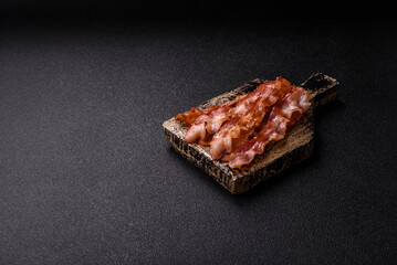 Cooked crispy bacon, slices of roast pork for an English breakfast. Fried bacon
