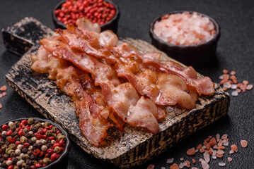 Cooked crispy bacon, slices of roast pork for an English breakfast. Fried bacon