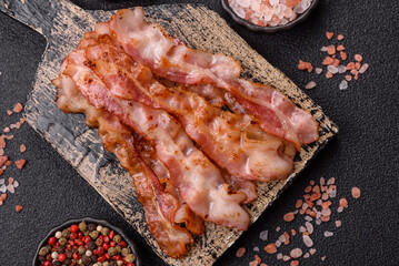 Cooked crispy bacon, slices of roast pork for an English breakfast. Fried bacon