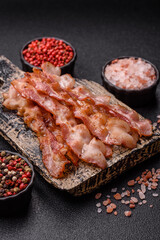 Cooked crispy bacon, slices of roast pork for an English breakfast. Fried bacon