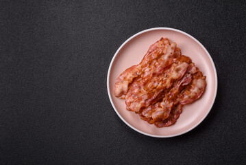 Cooked crispy bacon, slices of roast pork for an English breakfast. Fried bacon