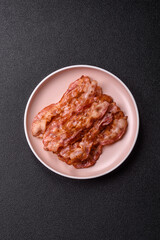Cooked crispy bacon, slices of roast pork for an English breakfast. Fried bacon