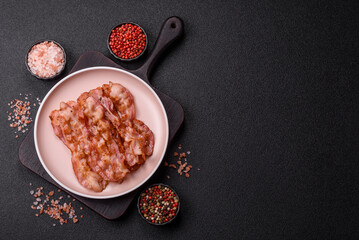 Cooked crispy bacon, slices of roast pork for an English breakfast. Fried bacon