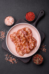 Cooked crispy bacon, slices of roast pork for an English breakfast. Fried bacon