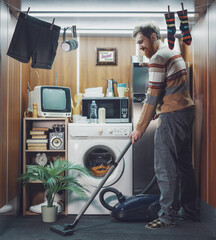 Man cleaning up his micro apartment and vacuuming the floor