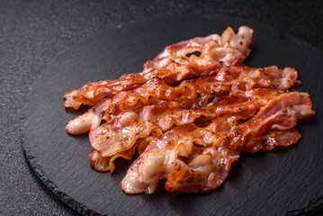 Cooked crispy bacon, slices of roast pork for an English breakfast. Fried bacon