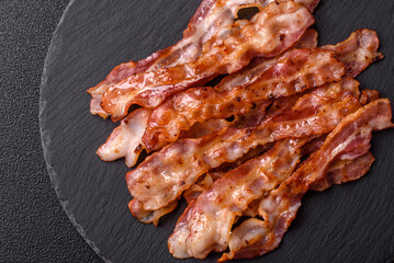 Cooked crispy bacon, slices of roast pork for an English breakfast. Fried bacon