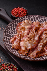 Cooked crispy bacon, slices of roast pork for an English breakfast. Fried bacon