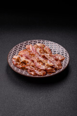 Cooked crispy bacon, slices of roast pork for an English breakfast. Fried bacon