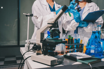 Scientist pipetting medical samples into microplate in laboratory