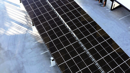 High-Angle View of Solar Panels Installed on Parking Lot Roofs for Sustainable Energy Generation.