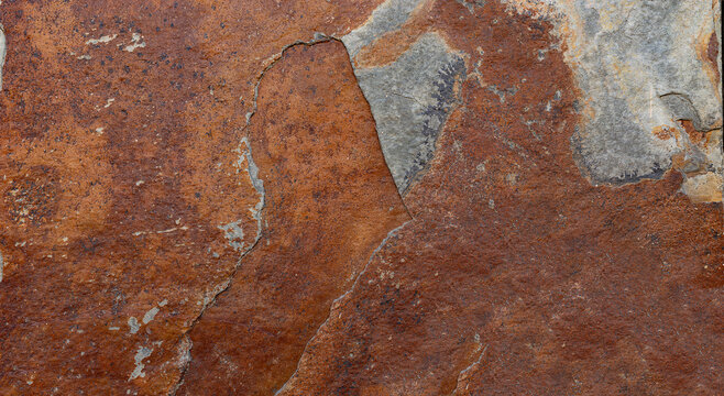 Facade with red phyllite stone cladding, natural and rustic texture