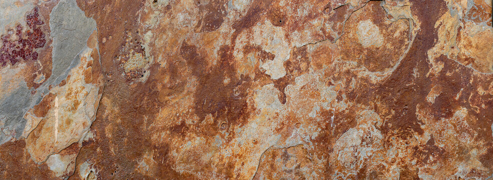 Facade with red phyllite stone cladding, natural and rustic texture