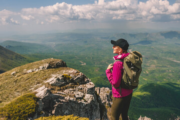 Young Woman Tourist Traveling in Mountains