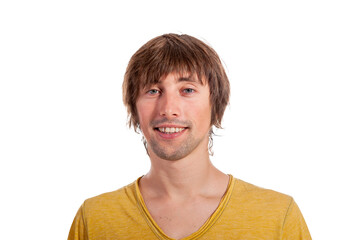 Young man in a yellow shirt smiling against a bright backdrop
