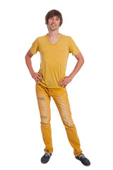 Young man poses confidently in bright yellow attire against plain backdrop