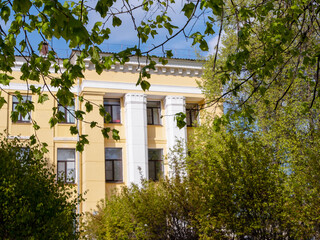 fragment of yellow administrative building on sunny day, selective focus