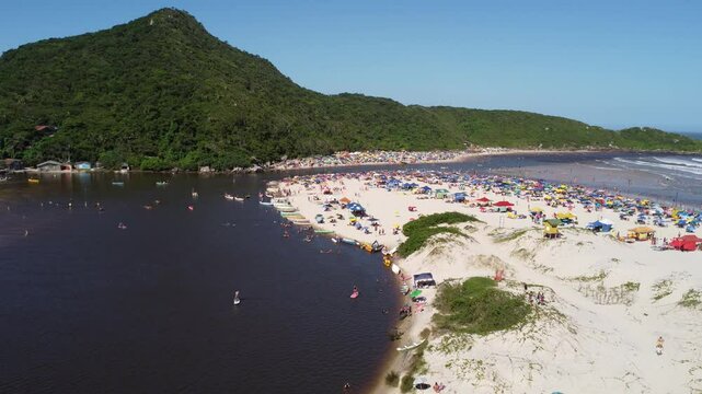 4K Drone Pullback Over River and Beach at Guarda do Emba&uacute;, Brazil