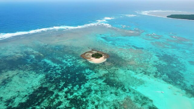Guyam Island with tropical Sandbar and Palm Trees surrounded by Clear Water on a sunny bright day