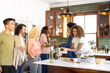 Friends gathering in modern kitchen, enjoying wine and conversation, smiling warmly