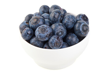 Fresh ripe blueberries in white ceramic bowl, isolated on white background