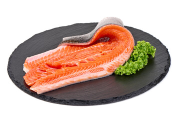 Raw Atlantic salmon fillet with skin and green lettuce on slate, isolated on white background.