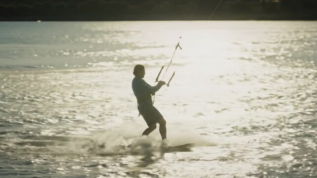 Kitesurfer Riding Waves at Sunset