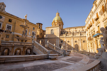 Naklejka premium Early morning light bathes Fontana Pretoria and its surrounding baroque buildings in warm tones. The image evokes timeless beauty and is ideal for promoting cultural tourism and Italian elegance