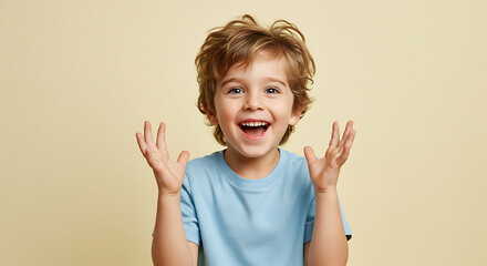Happy excited little boy with hands up in the air looking surprised and joyful portrait photography
