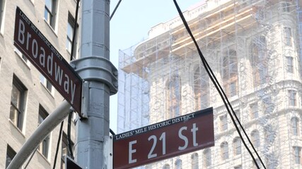 Broadway street road sign, Manhattan midtown district architecture, New York City corner. Traffic signage. Flatiron Building near Madison Square Park. Crossroad of 23 street, Bway and 5 Fifth avenue.