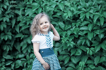 Cute little girl  on the meadow in spring day